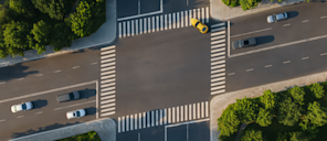 Aerial view of a street intersection where the crosswalks form a slanted parallelogram, imitating the Stripe logo.